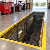 Safety net installed in an oil change service bay pit area to protect workers from falls.